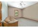 Bedroom with neutral paint, carpet flooring, and a large leather couch at 975 Cr 542E, Bushnell, FL 33513