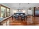 The dining area includes hardwood floors, a window, dining table set, and views to a bedroom at 975 Cr 542E, Bushnell, FL 33513