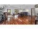 A dining area featuring hardwood floors, a dining table set, and a view into the entryway and a bathroom at 975 Cr 542E, Bushnell, FL 33513