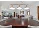 A dining area features a set table, shiny hardwood floors, sightlines to the kitchen, and views to other rooms at 975 Cr 542E, Bushnell, FL 33513