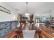 A spacious dining room with a table set, hardwood floors, and sightlines to the kitchen and living room at 975 Cr 542E, Bushnell, FL 33513