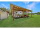 Open-air shelter with metal roof and wooden beams, providing an ideal space to park your horse trailer and work equipment at 975 Cr 542E, Bushnell, FL 33513