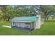 Charming cottage with a screened porch, offering a serene outdoor living space at 975 Cr 542E, Bushnell, FL 33513