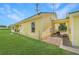 Exterior view of a well-maintained yellow home with a lush green lawn at 975 Cr 542E, Bushnell, FL 33513