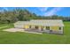 Charming yellow ranch home with a metal roof and a covered porch on a large lot at 975 Cr 542E, Bushnell, FL 33513