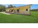 View of the covered front porch with wood posts and railing on this country home at 975 Cr 542E, Bushnell, FL 33513