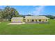Charming yellow ranch home with a metal roof, a covered porch and an oversized two-car garage at 975 Cr 542E, Bushnell, FL 33513