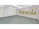 Bright garage space with natural light, featuring multiple windows and a door for easy access at 975 Cr 542E, Bushnell, FL 33513