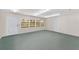 Spacious garage with natural light, multiple windows, and a convenient entry door at 975 Cr 542E, Bushnell, FL 33513