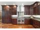 A full view of the kitchen featuring stainless steel appliances, dark cabinetry, and granite countertops at 975 Cr 542E, Bushnell, FL 33513