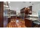 Large kitchen with an island, stainless steel appliances, wooden cabinets, granite countertops, and hardwood flooring at 975 Cr 542E, Bushnell, FL 33513