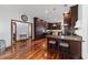 Open layout kitchen with hardwood floors, wooden cabinetry, granite countertops, and stainless steel appliances at 975 Cr 542E, Bushnell, FL 33513