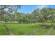 Lush acreage with mature trees and wooden perimeter fence at 975 Cr 542E, Bushnell, FL 33513