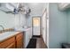 Well-organized laundry room featuring a sink, washer, dryer, and ample storage shelves at 975 Cr 542E, Bushnell, FL 33513