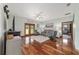 A living room includes hardwood floors, chairs, a couch, a ceiling fan, and french doors to the outside at 975 Cr 542E, Bushnell, FL 33513