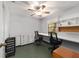 This office space features a built-in desk, shelving, ceiling fan, and natural light from the window at 975 Cr 542E, Bushnell, FL 33513