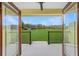 Open patio showcasing an expansive, green lawn and picturesque rural scenery at 975 Cr 542E, Bushnell, FL 33513