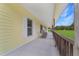 View of the covered front porch with rocking chairs overlooking the front yard at 975 Cr 542E, Bushnell, FL 33513