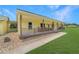 View of the wrap-around covered front porch with wood posts and railing on this country home at 975 Cr 542E, Bushnell, FL 33513