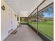Inviting screened porch with ample space for seating and relaxing, overlooking the spacious yard at 975 Cr 542E, Bushnell, FL 33513