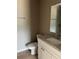 Compact bathroom featuring a granite vanity top, modern fixtures, and a clean, functional design at 10375 Se 126Th Ln, Belleview, FL 34420