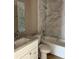 Modern bathroom featuring marble tile, granite countertop, and a sleek, clean design at 10375 Se 126Th Ln, Belleview, FL 34420