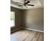 Inviting bedroom with wood-look floors, a ceiling fan, and natural light from the window at 10375 Se 126Th Ln, Belleview, FL 34420