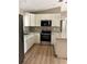 Contemporary kitchen featuring white cabinets, granite countertops, and stainless steel appliances at 10375 Se 126Th Ln, Belleview, FL 34420