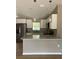 Modern kitchen with stainless steel appliances, granite counters, and bright overhead lighting at 10375 Se 126Th Ln, Belleview, FL 34420