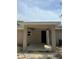 View of the covered patio area featuring neutral colors, a concrete floor, and an open door to the interior at 10375 Se 126Th Ln, Belleview, FL 34420