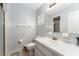 Clean bathroom featuring white vanity, toilet, and shower with simple design and functional layout at 10720 Sw 63Rd Ave, Ocala, FL 34476