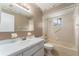 Well-lit bathroom with a tub/shower combination, vanity, and decorative seashell themed wallpaper at 10720 Sw 63Rd Ave, Ocala, FL 34476