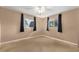 Comfortable bedroom with two windows, neutral carpet, and ample natural light at 10720 Sw 63Rd Ave, Ocala, FL 34476