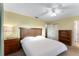 Cozy bedroom featuring a queen bed, ceiling fan, neutral carpet, and ample natural light at 10720 Sw 63Rd Ave, Ocala, FL 34476