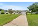 Inviting home showcasing a charming porch and attached garage, set on a well-maintained lot at 10720 Sw 63Rd Ave, Ocala, FL 34476