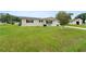 A well-manicured lawn complements this lovely single-story home with black shutters at 10720 Sw 63Rd Ave, Ocala, FL 34476