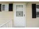 Close-up of the front door with classic design details and a charming exterior light fixture at 10720 Sw 63Rd Ave, Ocala, FL 34476