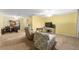 Spacious living room, featuring neutral carpet, and a view into an adjoining bonus space at 10720 Sw 63Rd Ave, Ocala, FL 34476