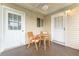 Cozy patio features a ceiling fan and an outdoor seating area with chairs and a round table at 10720 Sw 63Rd Ave, Ocala, FL 34476