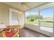 Relaxing screened porch with seating, ceiling fan, and views of the backyard at 10720 Sw 63Rd Ave, Ocala, FL 34476