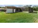 Manicured backyard with lush green grass, pool area, and fenced in yard at 10835 Se Highway 464C, Ocklawaha, FL 32179