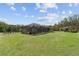 Large, well maintained backyard featuring a screened in pool, a guest house, and a dog run at 10835 Se Highway 464C, Ocklawaha, FL 32179