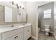 Well-lit bathroom features double sinks, vanity, and separate toilet area with shower at 10835 Se Highway 464C, Ocklawaha, FL 32179