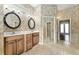 Bathroom featuring double sinks, framed mirrors, vanity and a tiled floor at 10835 Se Highway 464C, Ocklawaha, FL 32179