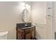 Elegant bathroom vanity features a vessel sink, dark countertop, and carved wood cabinet at 10835 Se Highway 464C, Ocklawaha, FL 32179