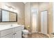 Neutral colored bathroom featuring a vanity, mirror, and separate shower with a glass door at 10835 Se Highway 464C, Ocklawaha, FL 32179