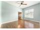 Bright bedroom with hardwood floors, ceiling fan, and window with natural light at 10835 Se Highway 464C, Ocklawaha, FL 32179