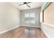 Bright bedroom with hardwood floors, ceiling fan, and window with natural light at 10835 Se Highway 464C, Ocklawaha, FL 32179