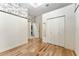 Bright bedroom features wood floors, closet, and contrasting wallpaper accent wall at 10835 Se Highway 464C, Ocklawaha, FL 32179