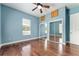Bright bedroom with hardwood floors, ceiling fan, and closet with mirrored doors at 10835 Se Highway 464C, Ocklawaha, FL 32179